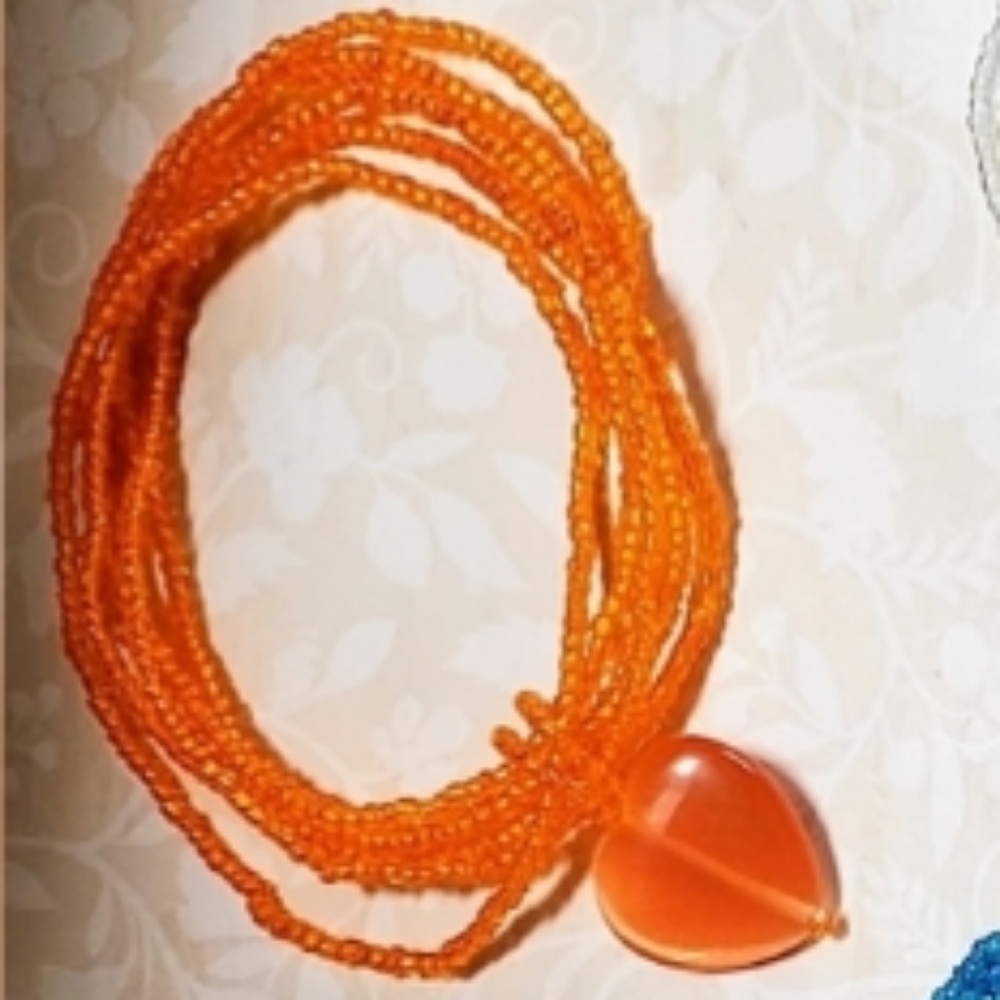 Heart Bracelet beaded Orange with Orange Heart charm and stretchy band.